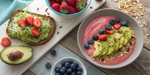 Healthy flat belly breakfast spread with avocado toast, smoothie bowl, and fresh berries.